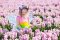 Little girl in fairy costume playing in flower field Royalty Free Stock Photo