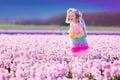 Little girl in fairy costume playing in flower field Royalty Free Stock Photo