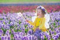 Little girl in fairy costume playing in flower field Royalty Free Stock Photo