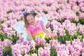 Little girl in fairy costume playing in flower field Royalty Free Stock Photo