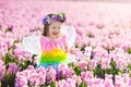 Little girl in fairy costume playing in flower field Royalty Free Stock Photo