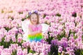 Little girl in fairy costume playing in flower field Royalty Free Stock Photo