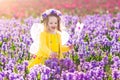 Little girl in fairy costume playing in flower field Royalty Free Stock Photo