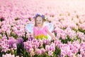Little girl in fairy costume playing in flower field Royalty Free Stock Photo