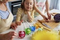 Little girl with family preparation natural dyes for coloring eggs