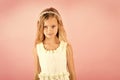 Little girl in fashionable dress, prom. Child girl in stylish glamour dress, elegance. Fashion model on pink background