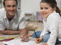 Little Girl With Father Coloring Book At Home Royalty Free Stock Photo