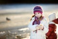 Little girl feeding ducks at winter Royalty Free Stock Photo