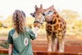 Little girl feeding giraffes Royalty Free Stock Photo