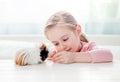 Little girl feeding her guinea pig Royalty Free Stock Photo