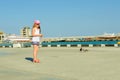 Little girl feeding pigeons on waterfront Royalty Free Stock Photo