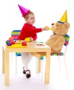 Little girl feeding Teddy bear Royalty Free Stock Photo