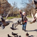 Little girl feeds pigeons