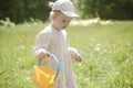 Beautiful child with dandelion flowers in park in summer. Happy kid having fun outdoors. Royalty Free Stock Photo