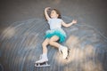 Little girl figure skating at imaginary skating rink arena