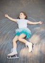 Little girl figure skating at imaginary skating rink arena