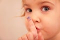 Little girl and finger with painted face