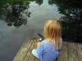 Little Girl Fishing From a Dock Royalty Free Stock Photo