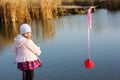 Little girl fishing from dock on lake. Royalty Free Stock Photo