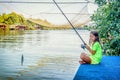 Little girl fishing on the river Bojana in Montenegro Royalty Free Stock Photo