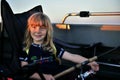 Little girl fishing trolling at boat with rod at sunset Royalty Free Stock Photo