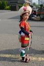 Cute little Taiwanese girl in garb of Amis Tribe from Hualien Matain with headdress and skirt, Kaohsiung, Taiwan