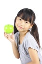 A little girl flexes her muscle while showing off the apple Royalty Free Stock Photo