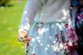 Little girl in a floral dress holding a daisy in her hand Royalty Free Stock Photo