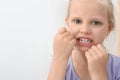 Little girl flossing teeth in bathroom Royalty Free Stock Photo