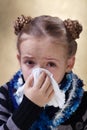 Little girl with the flu blowing her nose Royalty Free Stock Photo