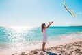 Little girl flying a kite on beach at sunset Royalty Free Stock Photo