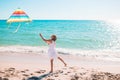 Little girl flying a kite on beach at sunset Royalty Free Stock Photo