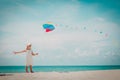 Little girl flying a kite at sky on beach Royalty Free Stock Photo