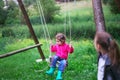 Little girl flying on swing in countryside. Childhood, Freedom,