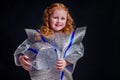 Little girl in foil diy space suit on a black background in the studio July 20, 1969 day of landing on the moon, child