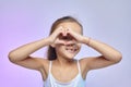 The little girl folded her hands in the shape of a heart Royalty Free Stock Photo