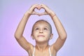 The little girl folded her hands in the shape of a heart Royalty Free Stock Photo