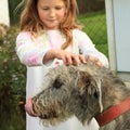 Little girl stroking a dog