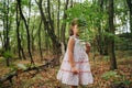 Little girl in the forest with ferns