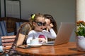 Little girl surfing on laptop trackpad with woman