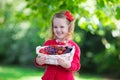 Little girl with fresh berries in a basket Royalty Free Stock Photo