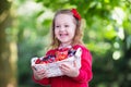 Little girl with fresh berries in a basket Royalty Free Stock Photo