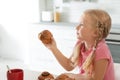 Little girl with freshly oven baked bun