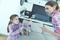 The little girl is frightened and protected from babysitting. She curses the girl and threatens her with a finger. Royalty Free Stock Photo