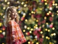 Little girl in front of a chrismas tree