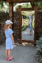 Little girl in front of distorting mirror