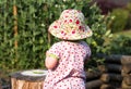 Cute little girl eating green peas in the summer garden Royalty Free Stock Photo