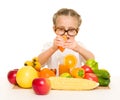 Little girl with fruits and vegetables make juice Royalty Free Stock Photo