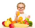 Little girl with fruits and vegetables make juice Royalty Free Stock Photo