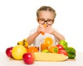 Little girl with fruits and vegetables make juice Royalty Free Stock Photo